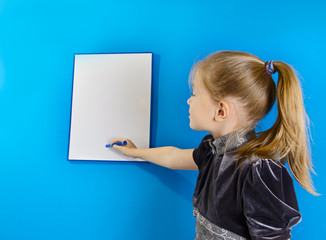 the girl shows a white plastic board