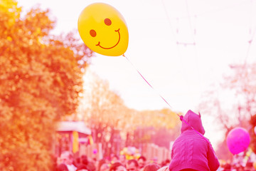 Yellow balloon with smile in the street