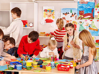 Child painting at art school.