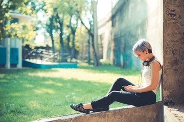 young beautiful short blue hair hipster woman with headphones mu