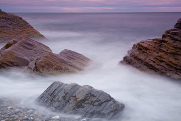 Big stones in the sea at sunrise
