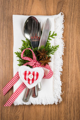 Christmas table setting on wooden table with copy text space