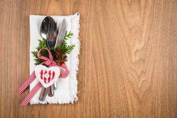 Christmas table setting on wooden table with copy text space