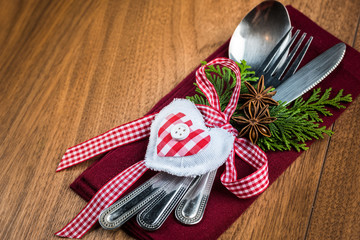 Christmas table setting on wooden table with copy text space