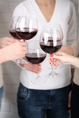 Woman hands with glasses of wine close-up