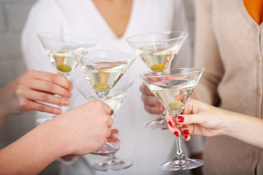 Woman hands with glasses of martini close-up