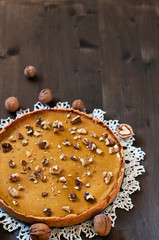 Walnut cake with pumpkin on wooden backgraund