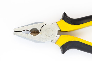Pliers black and yellow tool on white background close up