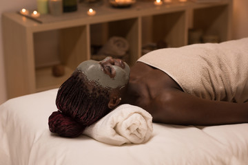 African woman relaxing in spa salon