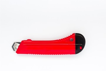 Red construction knife tool on white isolated