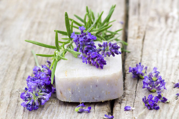 Obraz na płótnie Canvas bar of natural soap, lavender flowers and rosemary
