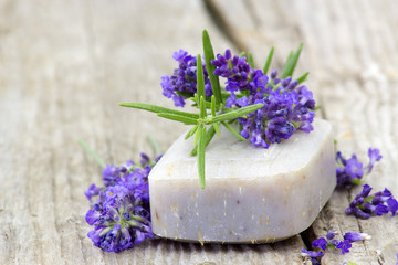 Obraz na płótnie Canvas bar of natural soap, lavender flowers and rosemary