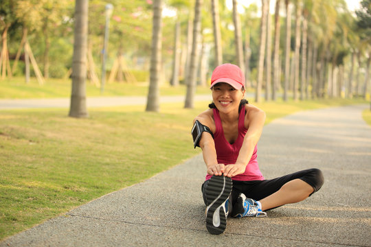 woman runner warm up at tropical park