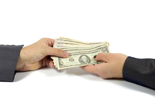 Female Hand Handing Cash To Male Hand Against White Background