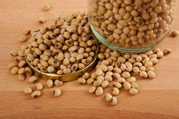 Soybean in a jar with lid off on wood table