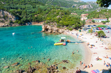 Palaiokastritsa, people sunbathe on the beach, Corfu, Greece.