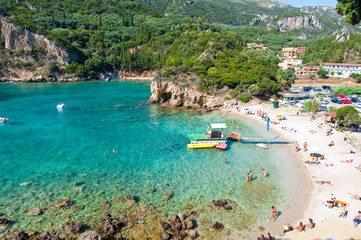 Palaiokastritsa beach, people sunbathe, Corfu island, Greece.