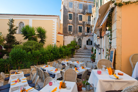 Outside restaurant invites guests to have a meal.Corfu, Greece.