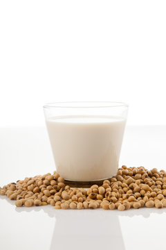Soy milk in glass with soybeans