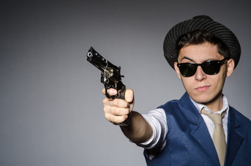 Man wearing sunglasses with gun