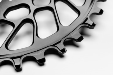 Black Bicycle chainring on white isolated backgorund. Premium gear. Close up. Anodized.