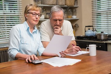 Senior couple working out their bills