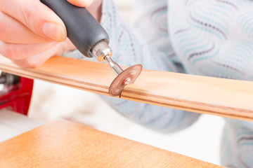 cutting the batten with rotary saw