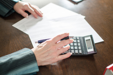 Accountant working with calculator