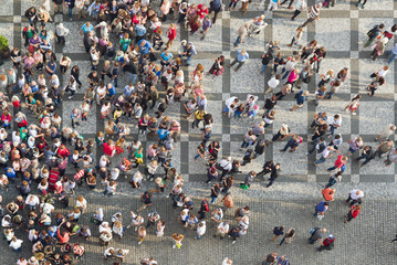 Toeristen op het oude stadsplein van Praag, grote groep mensen verzamelden zich op straat en keken omhoog naar de camera.