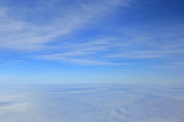 Naklejka na ściany i meble Blue sky over the surface of white clouds, aerial photography
