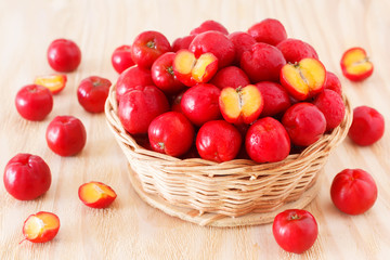 Malpighia glabra (red acerola), tropical fruit  in wicker busket