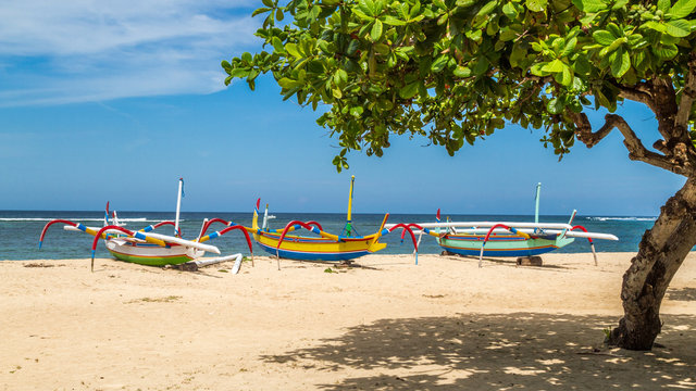 beach in bali, three boats ready to sail