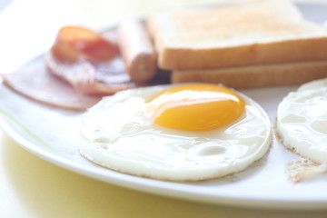 Breakfast with ham , fried egg and bread