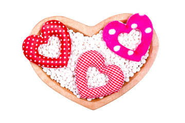pills in heart shape box on white background