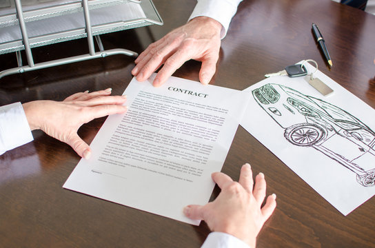 Dealer showing a car purchase contract
