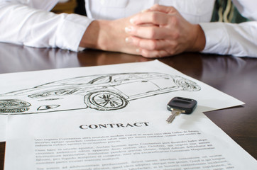 Naklejka premium Female car buyer sitting in front of contract