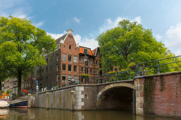 City view of Amsterdam canal, bridge and typical houses, Holland