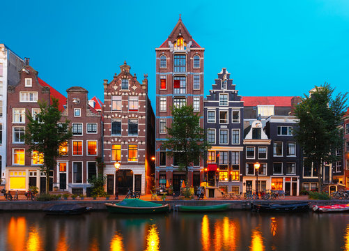 Night city view of Amsterdam canal with dutch houses