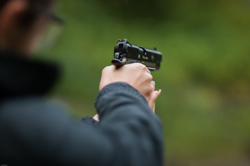 Fototapeta premium Woman holding a gun