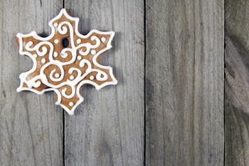Fototapeta na wymiar christmas snowflake gingerbread on wooden background