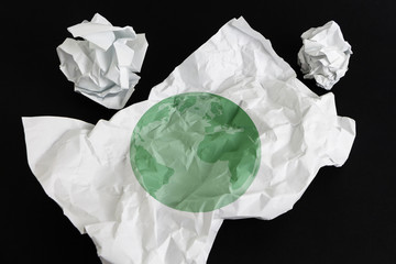 Crumpled paper sheet with Earth illustrated on it, isolated
