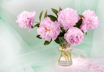 Still life with beautiful pink peonies in a glass vase