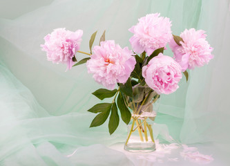 Still life with beautiful pink peonies in a glass vase