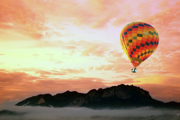 Fototapeta na wymiar Colorful hot-air balloons flying over the mountain