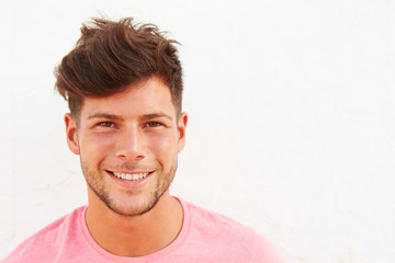 Obraz premium Portrait Of Young Man Standing Outdoors Against White Wall