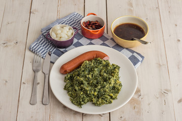 Boerenkool with smoked sausage on a white plate