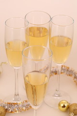 Still-life with wine glasses, gold spheres and a tinsel