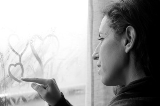 mid adult woman looking out of the window