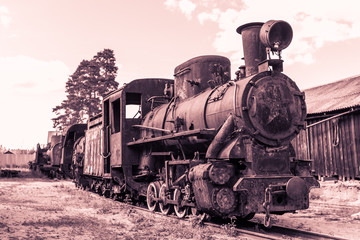 Fototapeta na wymiar old rusty steam locomotive in retro style in brown tones