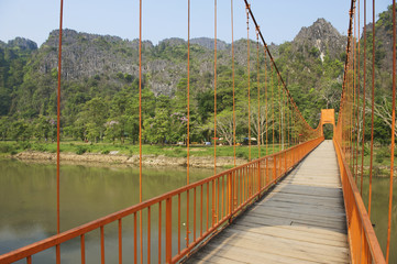 Fototapeta premium Pedestrian bridge across Nam Song river, Vang Vieng, Laos.